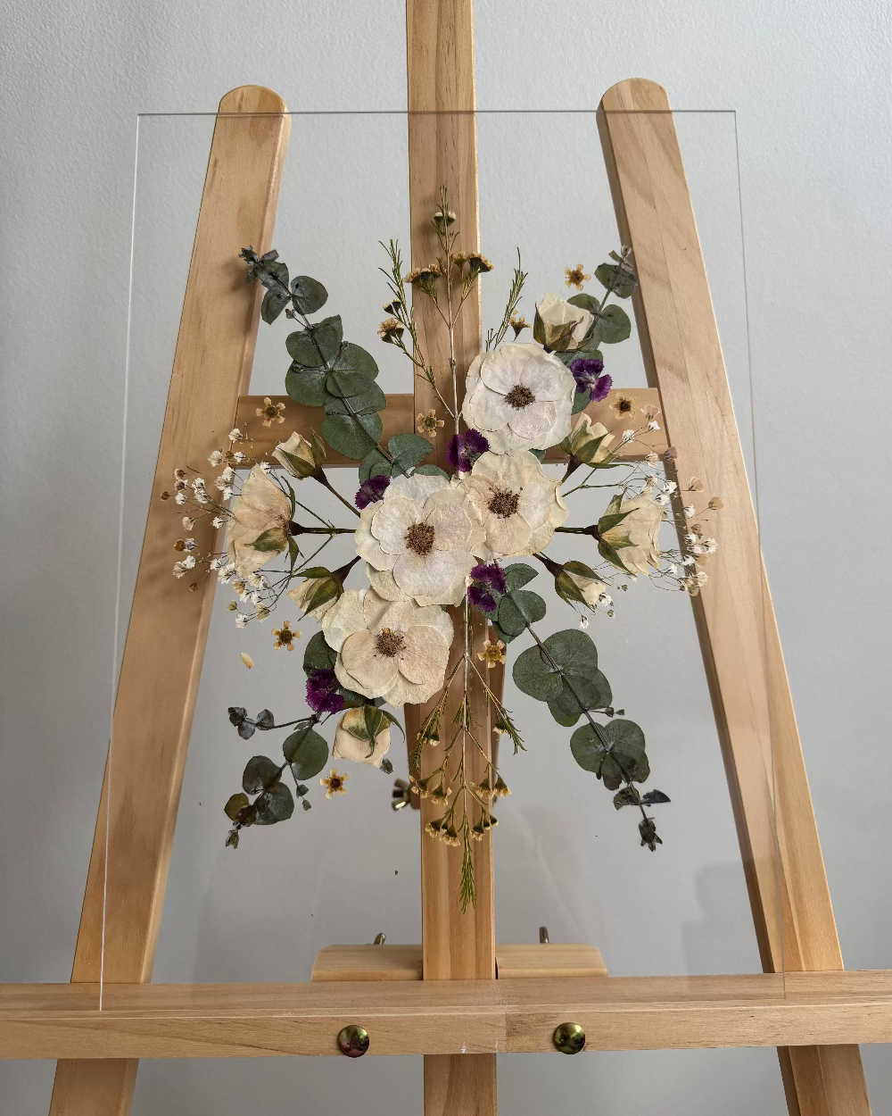 Four pressed white roses and foliage on an A3 frame
