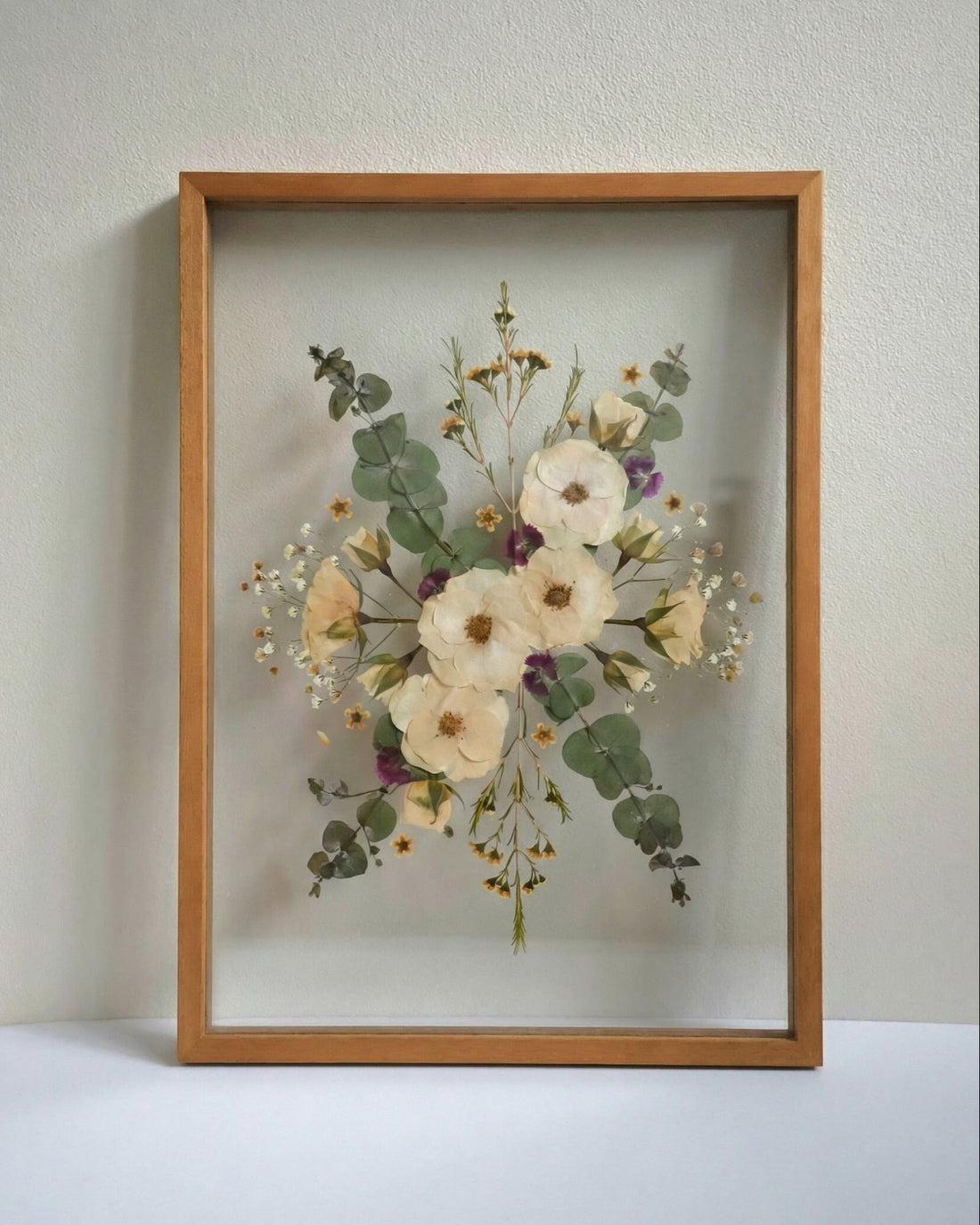 A3 custom pressed framed flower arrangement on a plain backgrou