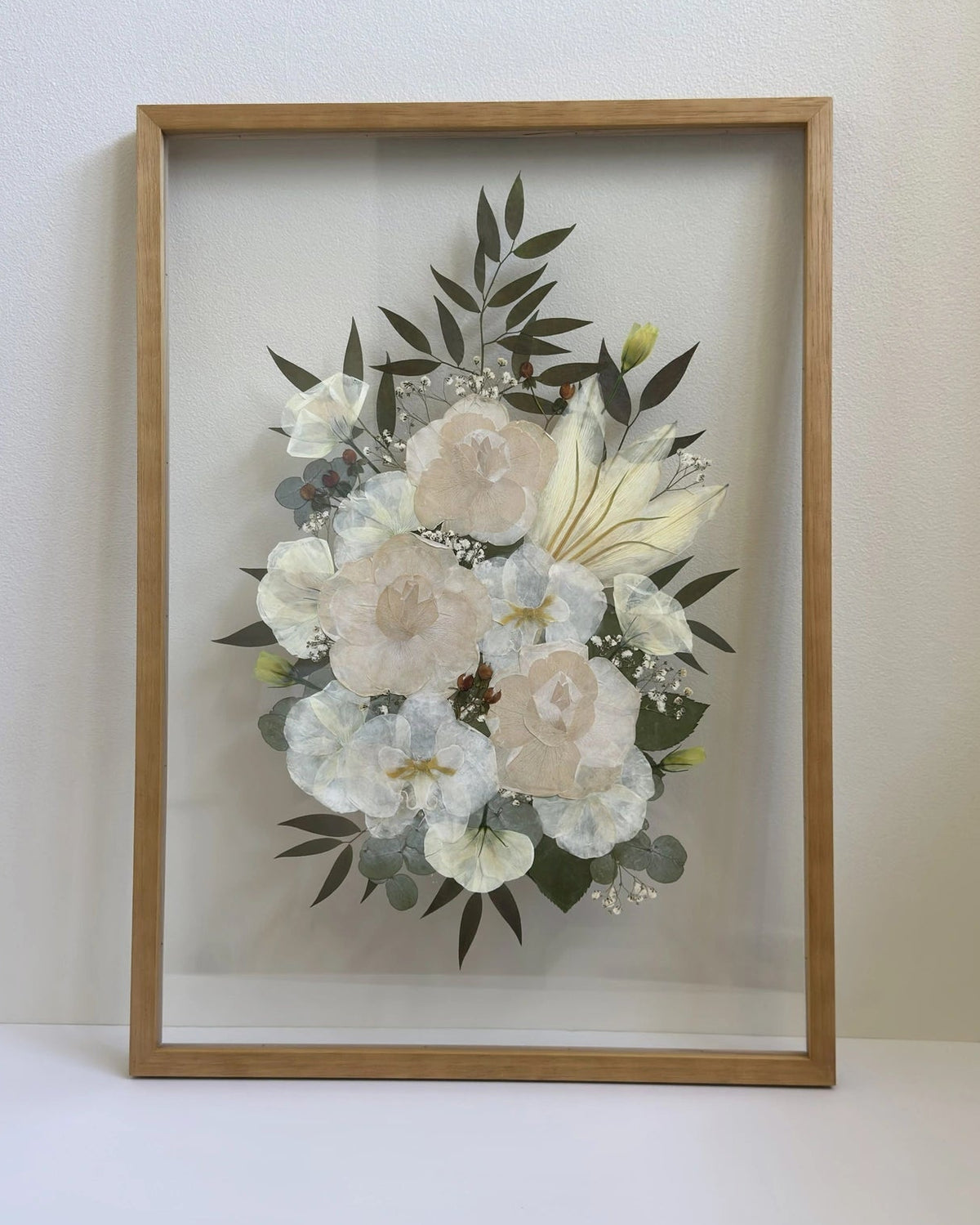 Pressed wedding bouquet framed in oak