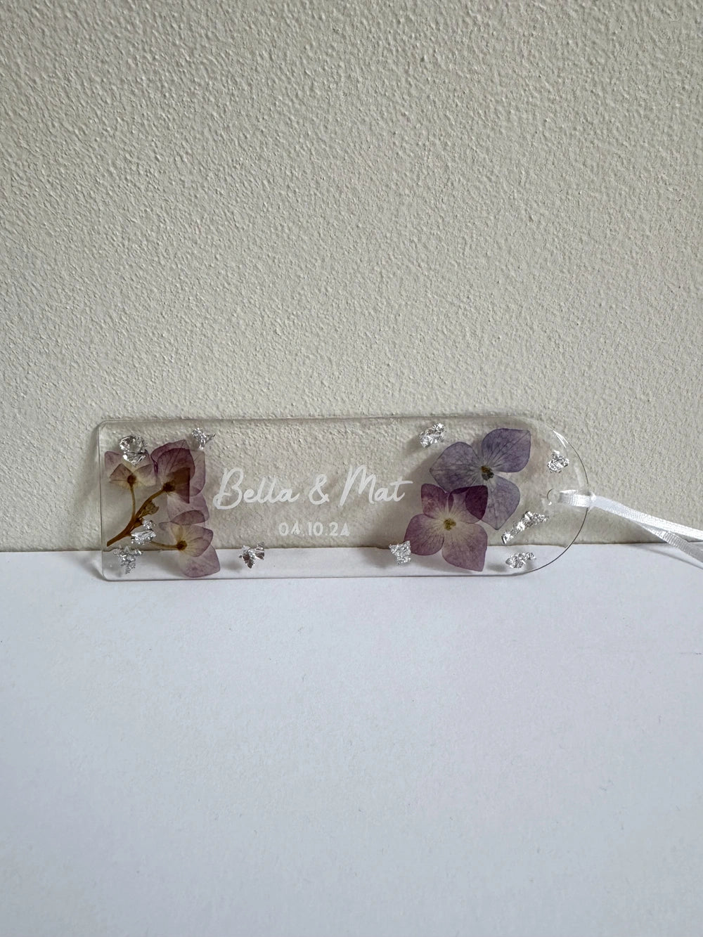 acrylic bookmark containing vinyl custom name, pressed flowers and silver foil
