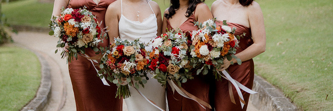 a bride and three bridesmaids holding wedding bouquets