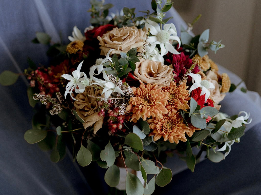 wedding bouquet sitting on top of a wedding veil